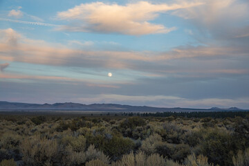 clouds and moon over the desert landscape