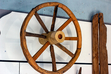 Old obsolete brown wooden cart wheel from archaeological excavations.