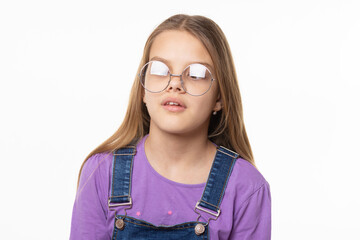 Portrait of a girl in glare glasses trying to look at her nose