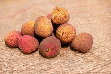 Heap of Lychee or Litchi Fruit on Burlap Background in Horizontal Orientation