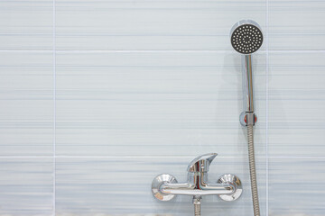 Blue tiled shower mixer and shower head - obrazy, fototapety, plakaty