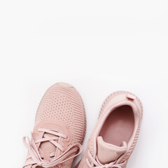 Pink female sneakers isolated on white background. Flat lay, top view