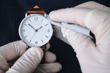 The watchmaker polishes the watch. Watch workshop