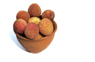 Stack of Organic Lychee or Lichi Fruits in a Clay Bowl Isolated on White Background with Copy Space for Texts Writing in Horizontal Orientation