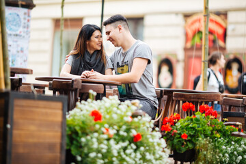 couple posing on the streets of a European city in summer weather.