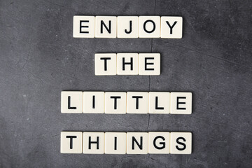 Fototapeta na wymiar The motivational phrase Enjoy the little things