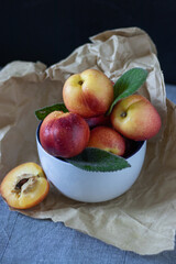  Peaches in a plate on a table on a dark background