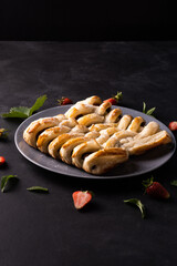 Chocolate puff pastry. Home baked dark chocolate sweet pie on black background with copy space