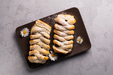 Chocolate puff pastry. Home baked dark chocolate sweet pie on grey background with copy space