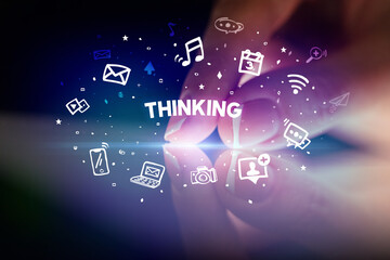 Finger touching tablet with drawn social media icons and THINKING inscription, social networking concept