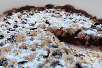 cherry pie on a white dish with a sliced slice close up.