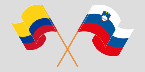 Crossed and waving flags of Colombia and Slovenia