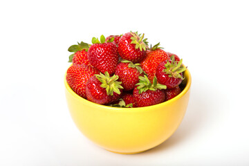 Strawberries in a yellow bowl on a white background.