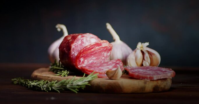 Slices salami with garlic and rosemary will slowly rotate.