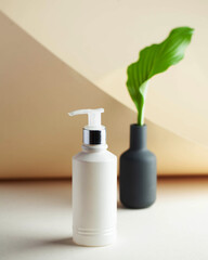 White cosmetic dispenser with space for your logo. Spa concept, skin care. Copy space.