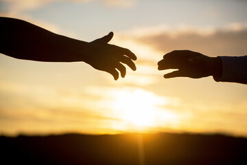 Giving a helping hand. Friendly handshake, friends greeting, teamwork, friendship. Rescue, helping gesture or hands. Outstretched hands, salvation, help silhouette, concept of help - obrazy, fototapety, plakaty