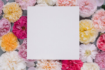 Blank square paper on  floral pattern made of different roses.  Branding mock up, holiday marketing concept.