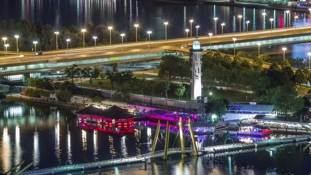 Aerial panoramic view over Vienna city with copa beach, Ponte Kagrana footbridge and a riverside promenade night timelapse in Austria. Illuminated skyline from Danube Tower viewpoint