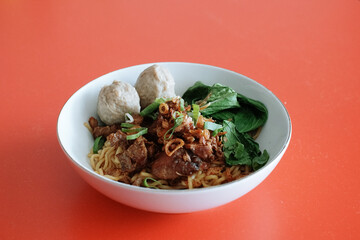 Chicken noodles with beef meatballs and fresh mustard leaves. beef rib