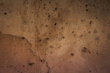 Detailed close up of a concrete wall with surface patterns, marks and textures. Grungy brown background.