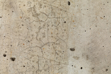Detailed surface patterns and textures of buff coloured concrete wall close-up. Grunge background with copy space.