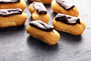 Traditional French dessert. Eclair with chocolate icing. Pastery dessert concept