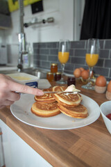 A celebration breakfast is served in this trendy renovated camper van, includes eggs, croissants, orange juice etc served on wooden kitchen surface and grey tiled kitchen area