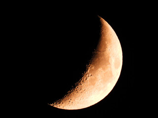 Zoom photo revealing great detail of half moon as seen on a clear night sky