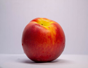 red-yellow nectarine on a white background