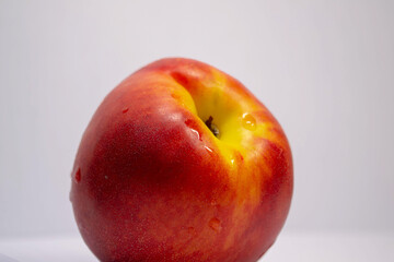 red-yellow nectarine on a white background