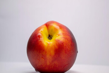 red-yellow nectarine on a white background