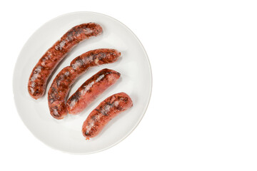 Roasted pepperoni served on a white plate with white background.