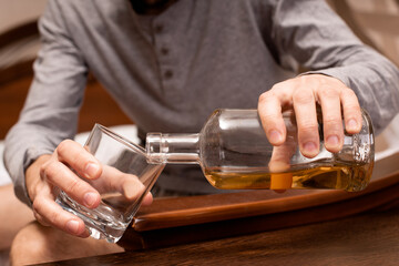 Depressed man drinks strong alcohol. Alcoholism concept.