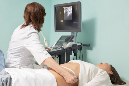 Doctor conducting ultrasound examination of woman in clinic