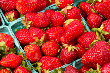 Closeup of several boxes of strawberries, isolated on a white background