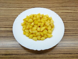Roasted potatoes on a white porcelain plate