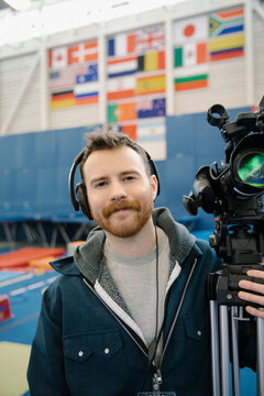 TV Cameraman With Camera In Sports Hall