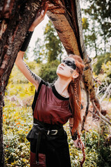 Girl in ethnic scandinavian costume in the forest