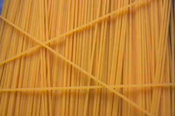 Close-up of some dried spaghetti forming vertical lines