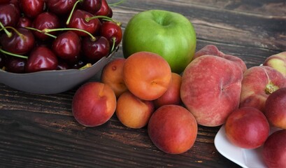Fototapeta na wymiar ripe berries and fruits on a wooden table