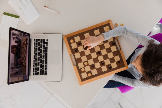 Girl playing chess on video call