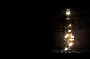 Bottle with lights on black background