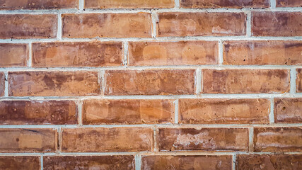 Old weathered brown-red brick wall