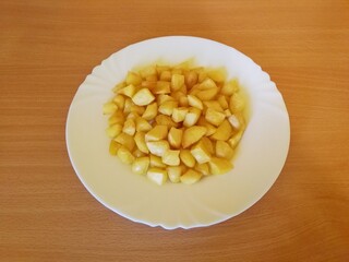 Roasted potatoes placed on a white porcelain plate