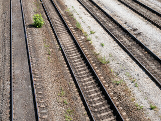 Obraz premium Railway, rails in perspective on a diagonal, top view. Railway station.