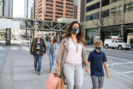 Multigenerational, Family In Face Masks Walking On City Sidewalk