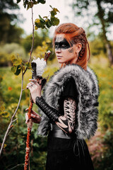 Girl in ethnic scandinavian costume in the forest