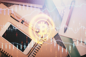 Double exposure of blockchain theme hologram over table with phone. Top view. Crypto technology...