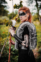 Fototapeta na wymiar Girl in ethnic scandinavian costume in the forest