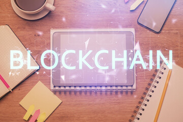 Double exposure of blockchain theme hologram over table with phone. Top view. Crypto technology...
